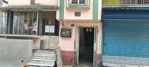 an entrance to a building with a door and stairs at KD Hostel days in kolkata