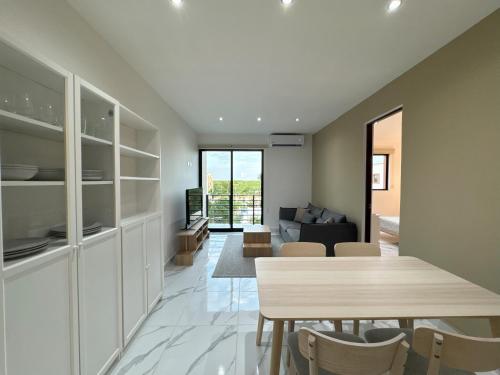 a dining room and living room with a table and chairs at OMBU Apartment New, equipped, 2 bedrooms, 2 bathrooms, pool in Cancún