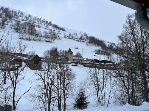 a train on a bridge in a snow covered mountain at Magnifique chalet à 3km PEYRAGUDES PYRENEES LUCHON in Gouaux-de-Larboust