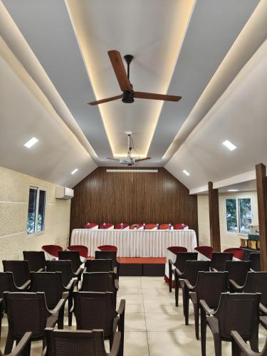 a conference room with chairs and a ceiling at Tranquil Riverview Inn in Kottayam