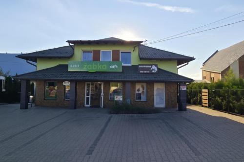 a building with a sign on the front of it at Chmurka in Górno
