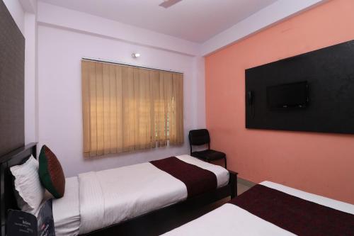 a hotel room with two beds and a flat screen tv at Hotel O BORO MA GUEST HOUSE in Salt Lake City