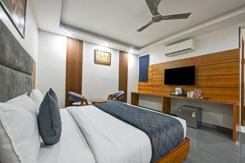 a bedroom with a bed and a flat screen tv at Kelvish Hotel- Delhi Airport in New Delhi