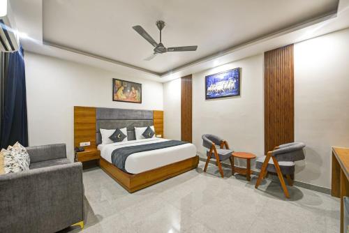 a hotel room with a bed and a couch at Kelvish Hotel- Delhi Airport in New Delhi