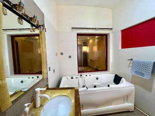 a bathroom with a tub and a sink at Seabreeze apartments in Mombasa