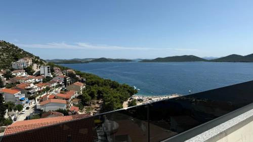 a view of a town and the ocean from a building at Apartmani Srdarović in Drage