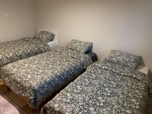 three beds in a small room with at Petit appartement dans une maison au calme in Bonneville