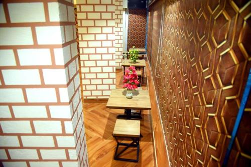 a hallway with a table and flowers on it at Backpackers's Village in Jāmb