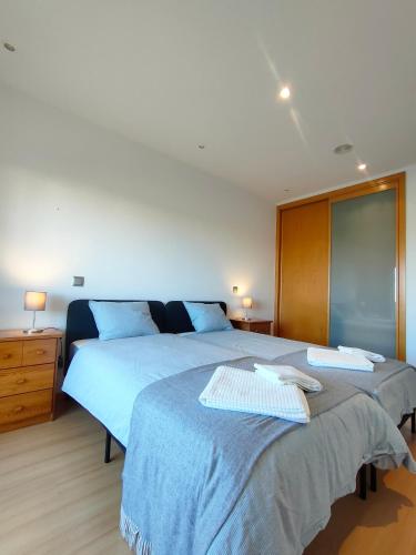 a bedroom with two beds with blue sheets at Welkome Inn Bemposta Confort T2 in Alvor