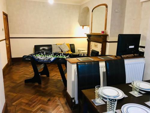 a kitchen with a table with plates on it at Castle Donington 5 Bed House 2 Baths Near EMA And Donington Park in Castle Donington