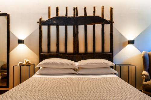 a bedroom with a large bed with two pillows at Podere Dell'Arco Country Charme in Viterbo