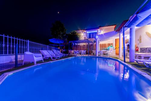 a swimming pool in a backyard at night at 4Ever Palace Design&Nature in Alcácer do Sal