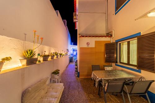 a room with a table and chairs in a building at 4Ever Palace Design&Nature in Alcácer do Sal