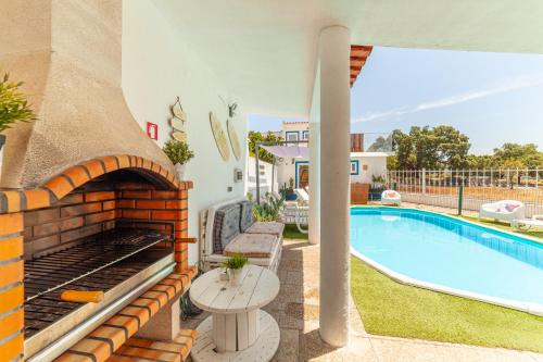 a villa with a swimming pool and a patio at 4Ever Palace Design&Nature in Alcácer do Sal