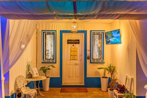 a room with a door and a table with plants at 4Ever Palace Design&Nature in Alcácer do Sal
