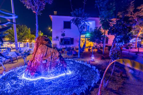 a fountain in the middle of a yard at night at 4Ever Palace Design&Nature in Alcácer do Sal