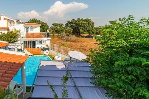a view of a swimming pool from the roof of a house at 4Ever Palace Design&Nature in Alcácer do Sal