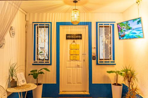 a door with a sign on it in a room with plants at 4Ever Palace Design&Nature in Alcácer do Sal