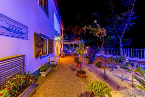 a building with a bunch of potted plants in a courtyard at 4Ever Palace Design&Nature in Alcácer do Sal