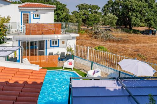 a house with a swimming pool next to a house at 4Ever Palace Design&Nature in Alcácer do Sal