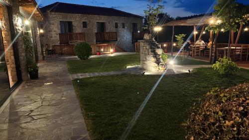 a garden at night with lights on the grass at Bujtina Rragam in Rragam
