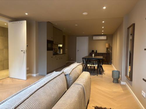 a living room with a couch and a table at Naest - Authentic Escapes Grand House in Nijmegen