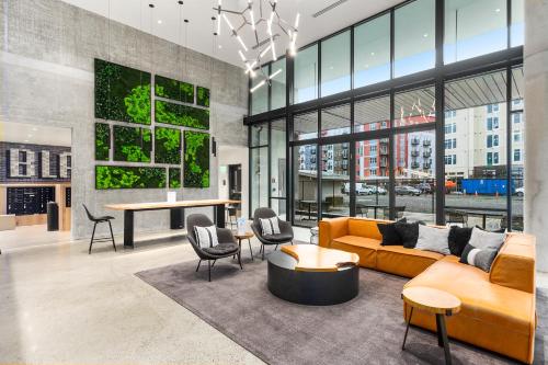 a living room with a yellow couch and a table at Airy and Open Corner Loft - 92 Walkscore in Redmond