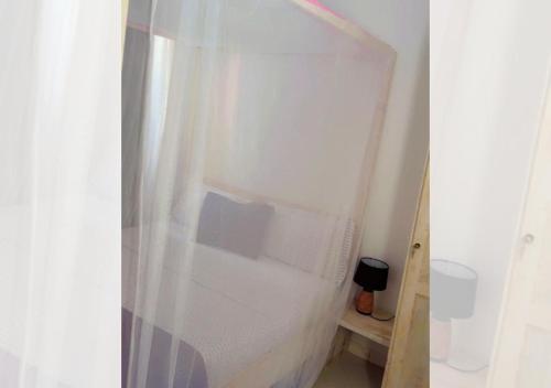 a bathroom with a shower curtain and a toilet at Chez Ouly in Dakar