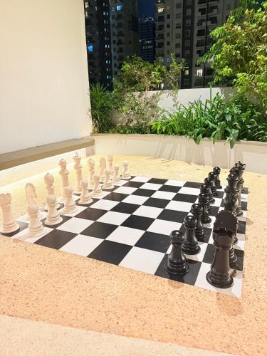 a chess board on a sidewalk with a chessboard at Chevalra Luxury TRI-ZEN Apartment in Central Colombo - Galle-Face & Lotus Tower View in Colombo