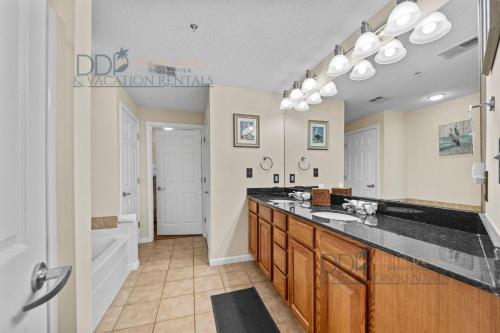 a large bathroom with a sink and a tub at Legacy Tower II 403 in Gulfport