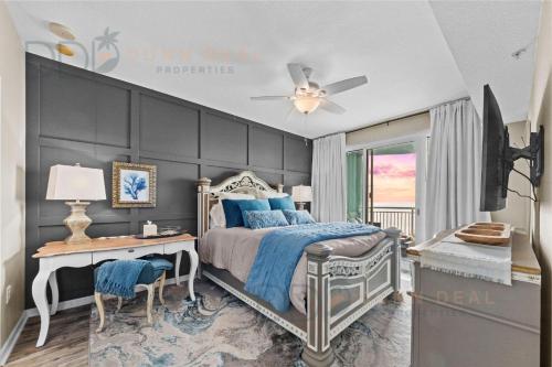 a bedroom with a bed and a desk and a ceiling fan at Legacy Tower II 608 Deluxe in Gulfport