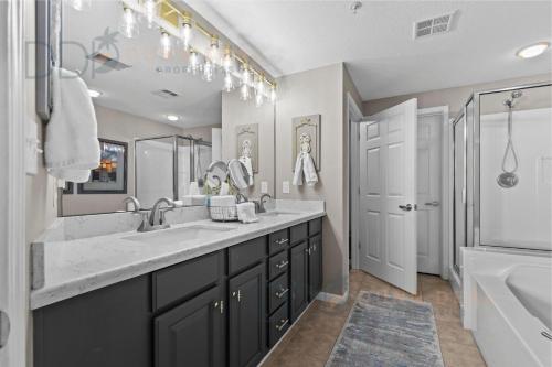 a bathroom with a large sink and a tub at Legacy Tower II 608 Deluxe in Gulfport
