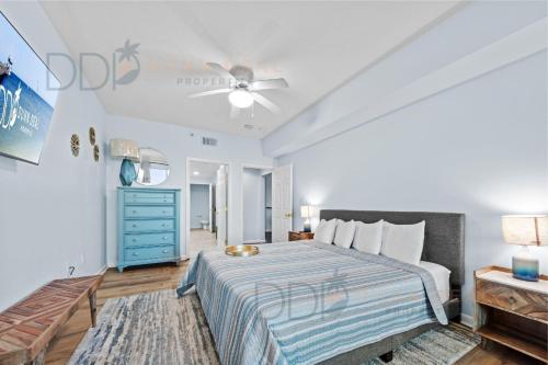 a bedroom with a bed and a blue dresser at Legacy Tower I 304 in Gulfport