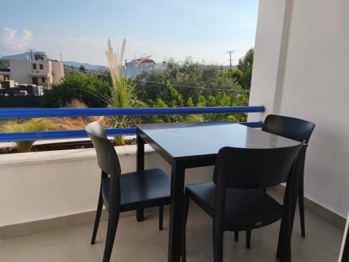 a table and chairs on a balcony with a view at Villa Maroula in Afantou