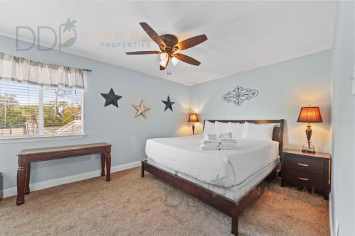 a bedroom with a bed and a ceiling fan at Oak Shores 77 in Biloxi