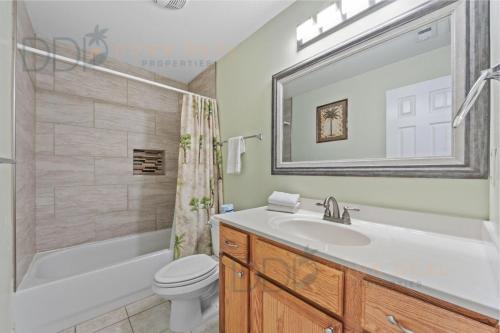 a bathroom with a sink and a tub and a toilet at Oak Shores 77 in Biloxi