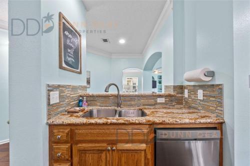 a kitchen with a sink and a mirror at Legacy Villa 1501 in Gulfport