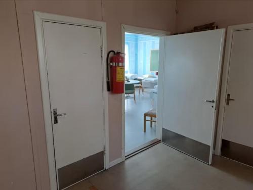 a fire hydrant in a room with two doors at Skolan - Boende Vindelälven in Gargnäs