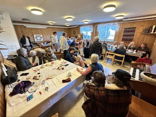 a group of people sitting around a table in a room at Skolan - Boende Vindelälven in Gargnäs