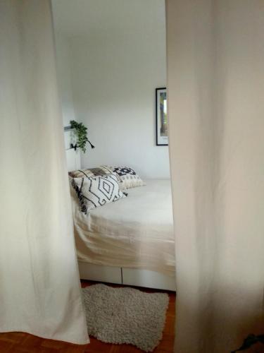 a bedroom with a bed through a doorway at Trudi's Apartment bei Bonn in Sankt Augustin
