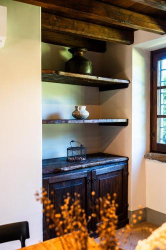 a kitchen with a wooden cabinet in a room at Podere Dell'Arco Country Charme in Viterbo