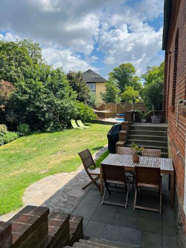 a patio with a table and chairs and stairs at Landhaus Kloster Marienfließ in Stepenitz