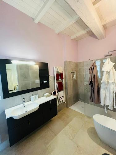 a bathroom with a sink and a shower and a tub at Agriturismo Il Molino in Quercianella