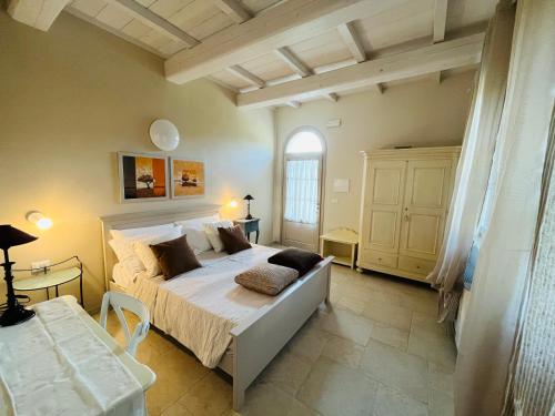 a bedroom with a large bed and a window at Agriturismo Il Molino in Quercianella