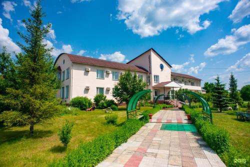 a house with a garden and a pathway at Дом отдыха Астана in Borovoye