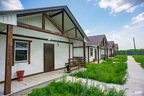 a row of houses with a pathway in front at Дом отдыха Астана in Borovoye