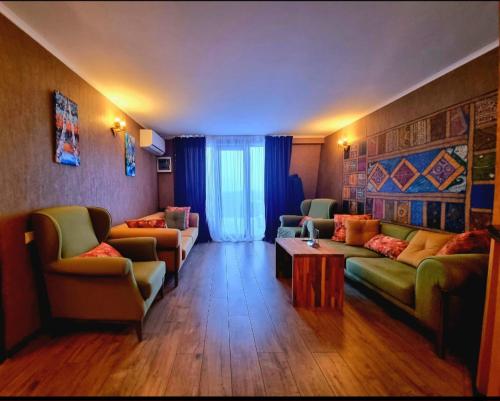 a living room with two couches and a table at Villa Gelati in Kutaisi