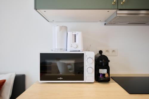 a microwave sitting on top of a table at Apartment Combaz 4 in Mellet