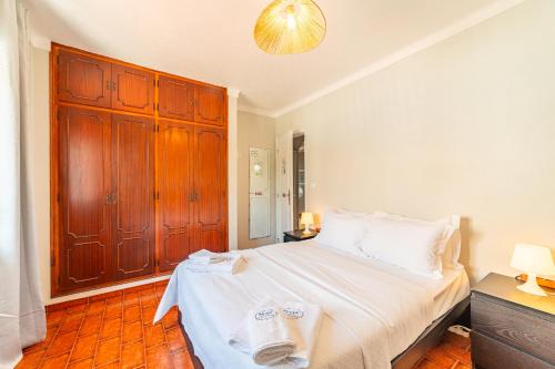 a bedroom with a bed and a wooden cabinet at 4Ever Palace Design&Nature in Alcácer do Sal