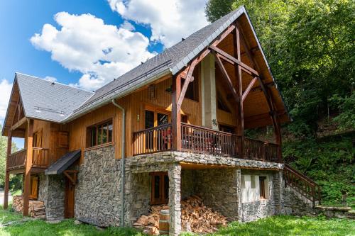 a large wooden house with a balcony on it at Magnifique chalet à 3km PEYRAGUDES PYRENEES LUCHON in Gouaux-de-Larboust